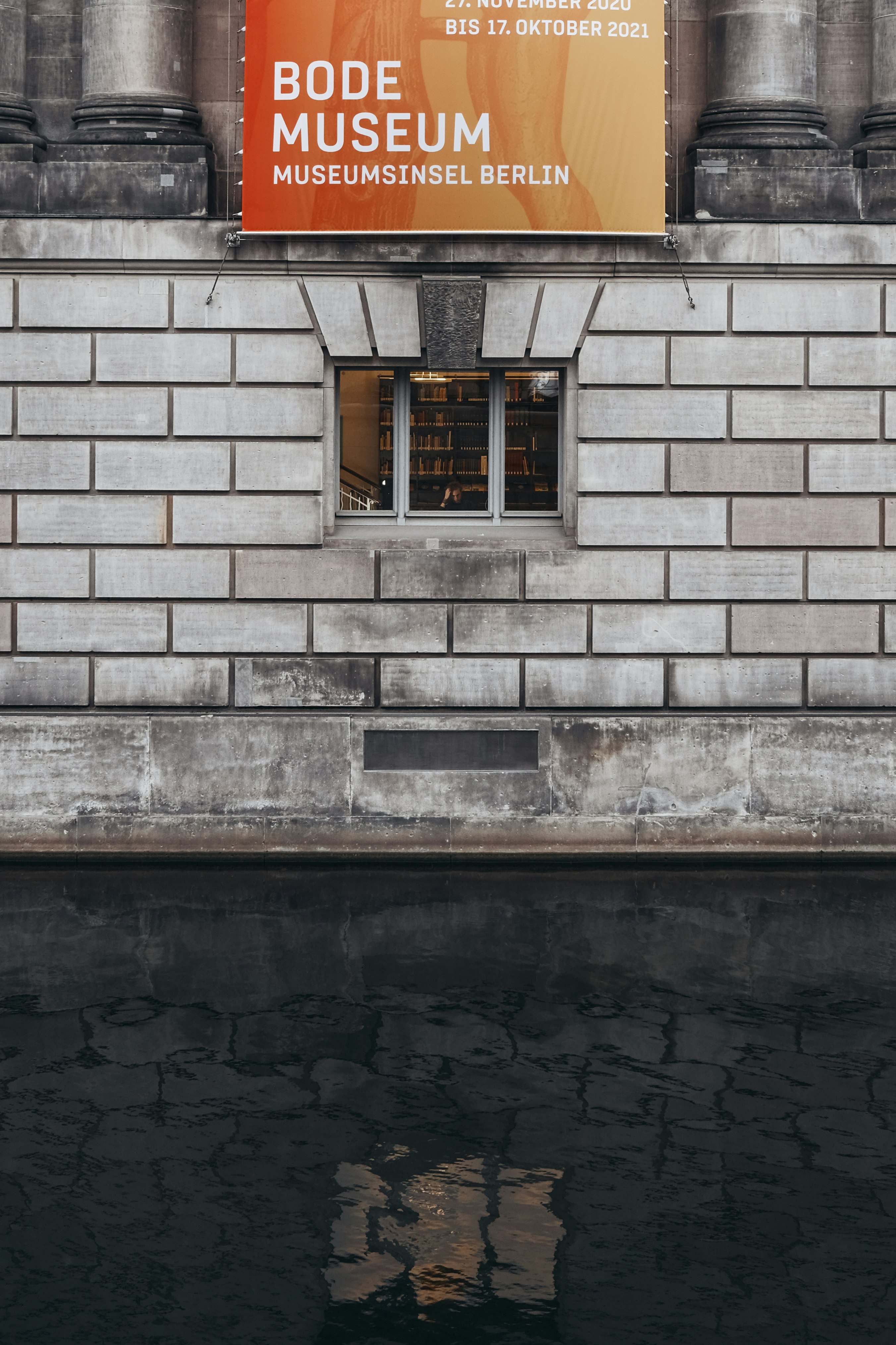 brown wooden window on gray brick wall